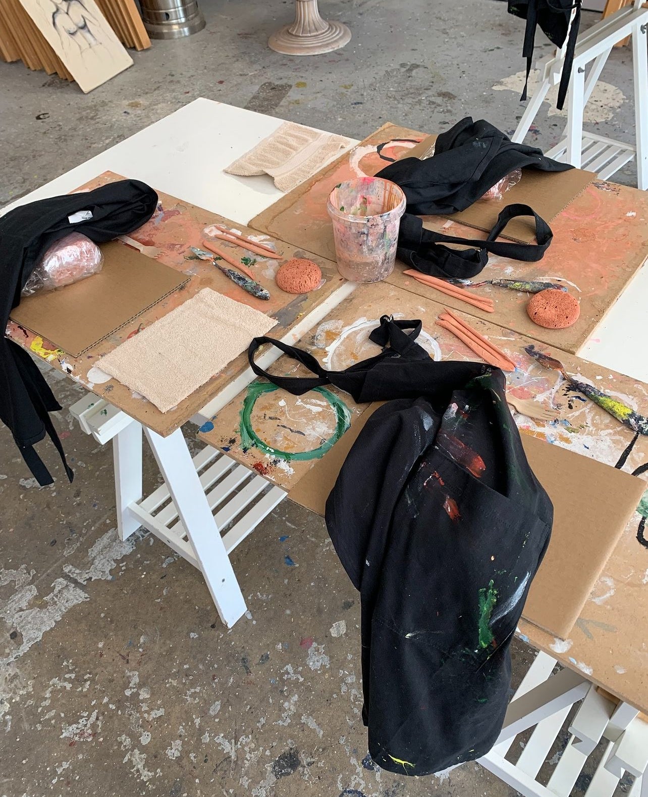 Clay workshop with aprons on table